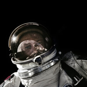 a black background with a photograph of an astronaut in a space suit