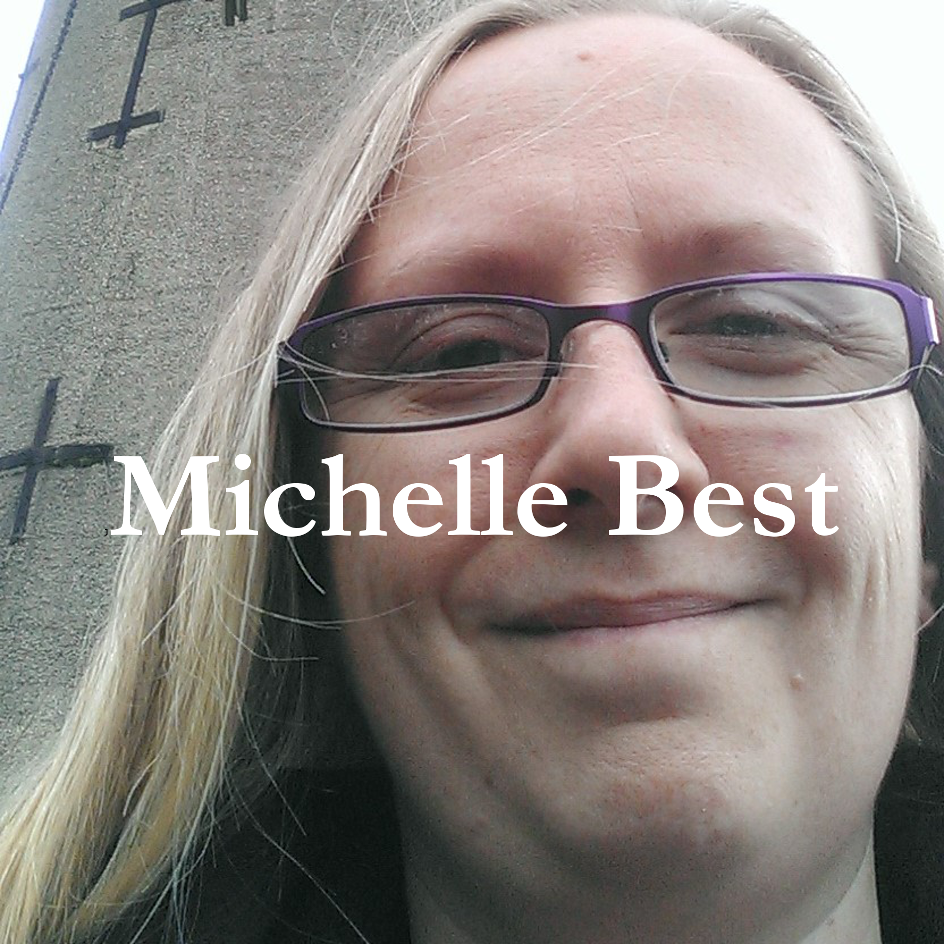 Photograph of a woman with blonde hair and glasses standing in front of a lighthouse, with her name - Michelle Best - superimposed over the top