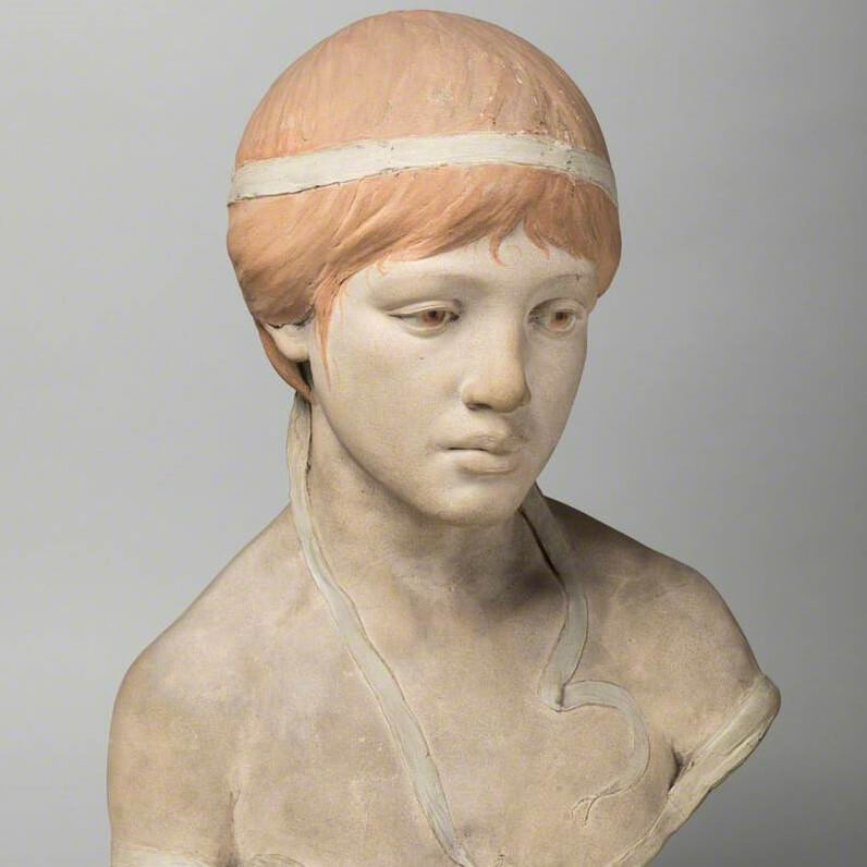 marble head of a girl with orange painted hair