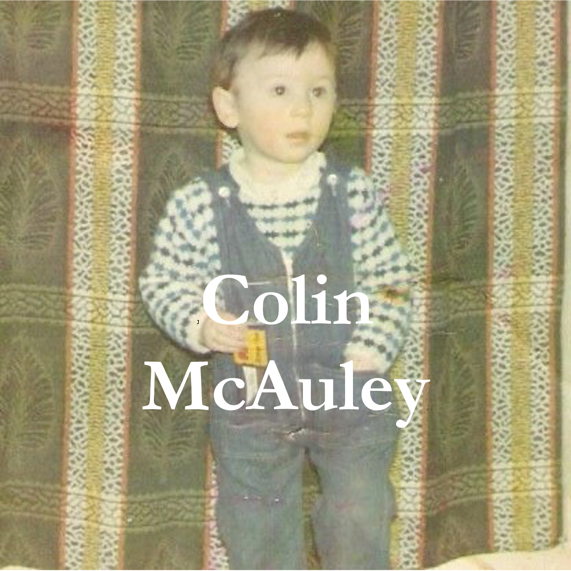 photograph of a small boy with a bar of chocolate in his dungarees packet with his name - the name of the author of this story - Colin McAuley - written across the top.