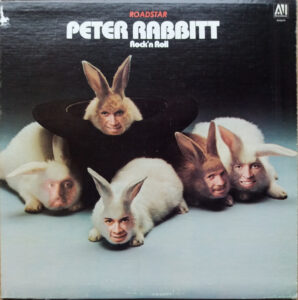 Record cover for a record called Peter Rabbitt with four white rabbits with human faces superimposed onto the rabbit's faces.