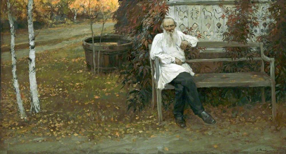 Landscape painting of Leo Tolstoy sitting on a garden bench. He is dressed in a long white peasant blouse and has a white beard. On the left hand side are two silver birches.